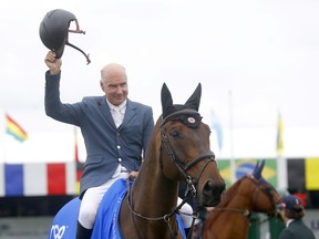 Canada's Mario Deslauriers and Uris De La Roque win the ATCO Cup in a jump off at the Spruce Meadows National in Calgary on Friday.