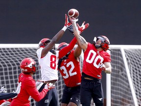 Calgary Stampeders players go up for a ball during training camp earlier this spring.