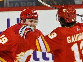 Flames linemates Matthew Tkachuk and Johnny Gaudreau celebrate a goal against the Seattle Kraken during NHL action at the Scotiabank Saddledome in this photo from April 12.