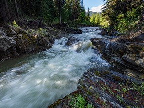 Water flows over rock shelves in Etherington Creek west of Longview, Ab., on Tuesday, July 5, 2022.