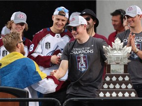 Cale Makar #8 of the Colorado Avalanche shakes hands with Gabriel Landeskog #92 while on-stage during the Colorado Avalanche Victory Parade and Rally at Civic Center Park on June 30, 2022 in Denver, Colorado.