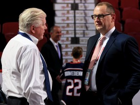 Calgary Flames general manager Brad Treliving (right) talks with Pittsburgh Penguins president of hockey operations Brian Burke prior to the first round of the NHL Draft at Bell Centre in Montreal on Thursday, July 7, 2022.