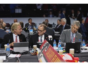 (L-R) Don Maloney, Brad Treliving and Tod Button of the Calgary Flames attend the 2022 NHL Draft at the Bell Centre on July 08, 2022 in Montreal, Quebec.