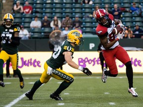 Edmonton Elks defensive back Scott Hutter chases Calgary Stampeders receiver Kamar Jordan at Commonwealth Stadium in Edmonton on Thursday, July 7, 2022.