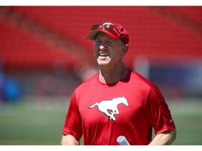 Stampeders coach Dave Dickenson jogs off the field during practice at McMahon Stadium in Calgary on Monday, July 11, 2022. Jim Wells/Postmedia