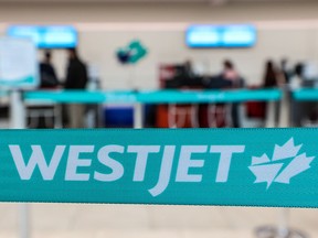 A WestJet check-in area at the Calgary International Airport was photographed on Tuesday, January 18, 2022. WestJet announced it would be consolidating or cancelling up to 20 per cent of its flights through Feb. 28.