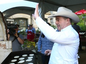 Alberta Premier Jason Kenney serves up pancakes at the Premier’s Pancake Breakfast in Calgary on Monday, July 11, 2022.