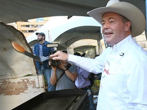 Alberta Premier Jason Kenney serves up pancakes at the Premier's Pancake Breakfast in Calgary on Monday, July 11, 2022.