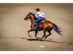 Cowgirl Wenda Johnson of Pawhuska, OK, sailed around the barrels in a time of 17.28 seconds during barrel-racing action at the Calgary Stampede rodeo on Monday, July 12, 2021. Al Charest / Postmedia