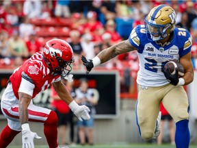 Winnipeg Blue Bombers running back Brady Oliveira carries the ball against the Calgary Stampeders at McMahon Stadium in Calgary on Saturday, July 30, 2022.