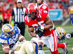 Calgary Stampeders running back Ka’Deem Carey scores a touchdown against the Winnipeg Blue Bombers at McMahon Stadium in Calgary on Saturday, July 30, 2022.