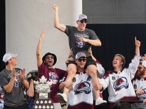 Denver, Colorado, USA; Colorado Avalanche defenceman Cale Makar (8) sits on the shoulders of right wing Mikko Rantanen (96) during the Stanley Cup Championship Celebration.