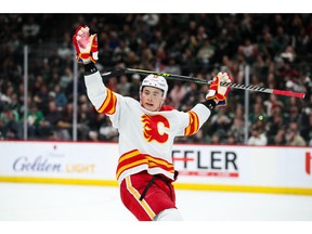 Apr 28, 2022; Saint Paul, Minnesota, USA; Calgary Flames defenseman Nikita Zadorov (16) reacts to the Minnesota Wild bench as he celebrates a goal by teammate center Elias Lindholm (28) in the third period at Xcel Energy Center.