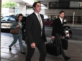 Former Vancouver Canucks winger Jake Virtanen arrives at BC Supreme Court for his sexual assault trial with lawyer Brock Martland in Vancouver, BC., on July 19, 2022.