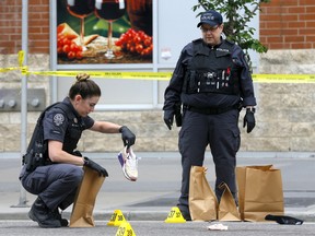 Calgary police investigate an early morning shooting in the Beltline at 14 Ave. and 1 St. S.E. in Calgary on Saturday, July 2, 2022.