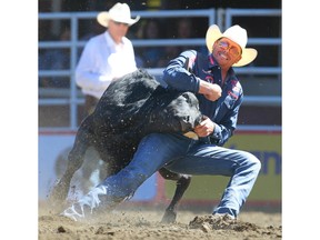 Donalda bulldogger Cody Cassidy planted his steer in a time of 5.8 seconds in the steer - wrestling event at the Calgary Stampede rodeo on Monday, July 11, 2022.