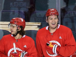 Johnny Gaudreau and Matthew Tkachuk share a laugh during a break in practice during training camp in this photo from Jan. 4, 2021.