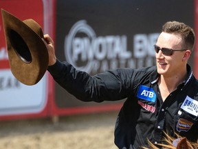 Big Valley cowboy Zeke Thurston takes a victory lap around the infield after winning day-money in the saddle-bronc event during the Calgary Stampede rodeo on Friday.