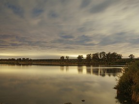 The Bow River lit by city light reflecting from clouds near Carseland, Ab.,. on Tuesday, August 9, 2022.