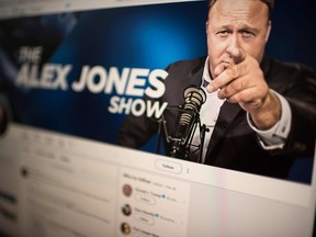 This picture showing a computer screen displaying the Twitter account of far-right conspiracy theorist Alex Jones is taken on Aug. 15, 2018 in Washngton D.C.