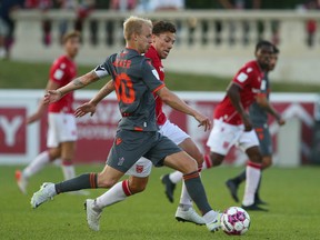 Forge FC’s Kyle Bekker moves the ball against Cavalry FC’s Ben Fisk on ATCO Field at Spruce Meadows on July 27, 2022. Forge won 2-1.