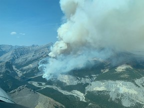 FILE PHOTO: Firefighters, helicopters and airtankers fighting an out-of-control wildfire north of Banff National Park near Black Rock Mountain, shown in a government handout photo on Sept. 6, 2020.