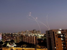 Streaks of light are seen as Israel's Iron Dome anti-missile system intercept rockets launched from the Gaza Strip towards Israel, as seen from Ashkelon, Israel, Sunday, Aug. 7, 2022.