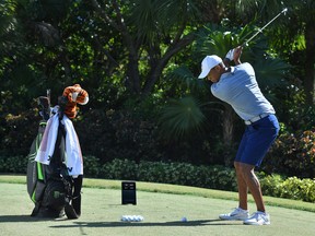 Golf legend Tiger Woods with the Full Swing KIT launch monitor.