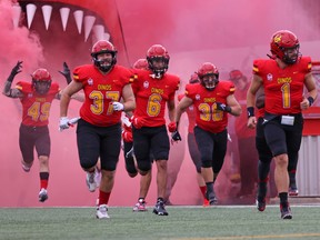 The University of Calgary Dinos, pictured running on to the McMahon Stadium field before their 2021 regular-season opener, face their first test of 2022 against the UBC Thunderbirds in the Kalamalka Bowl on Wednesday in Vernon, B.C.
