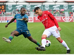 Canadian Premier League - Cavalry FC v York United FC - Calgary, Alberta, Canada  Aug, 27, 2022 York United FC defender Chrisnovic N'Sa and Cavalry Midfielder Jose Escalante vie for  ball possession.   CFC Media\ Mike Sturk