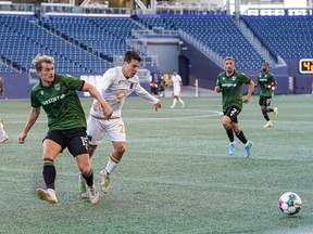 Cavalry FC (in green kit) battles Valour FC at IG Field in Winnipeg on Wednesday, Aug. 3, 2022.