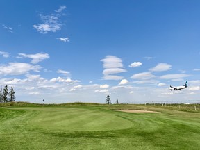 A plane lands just beyond the fifth green on the Runway Nine at Wingfield Golf Club. Located near the Calgary International Airport, the 27-hole hangout was rebranded and reopened in 2021.