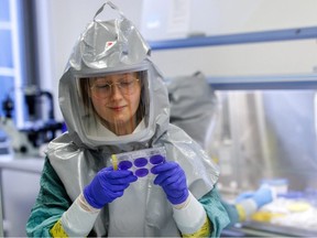 A biologist at the French-Austrian biotech firm Valneva works on an inactivated whole-virus vaccine against COVID-19 in a laboratory in Vienna, Austria, December 16, 2021.