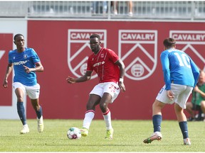 Cavalry defender Karifa Yao (C) works the ball upfield from the back line during CPL soccer action between Cavalry FC and FC Edmonton at ATCO Field at Spruce Meadows in Calgary on Saturday, July 30, 2022. Jim Wells/Postmedia