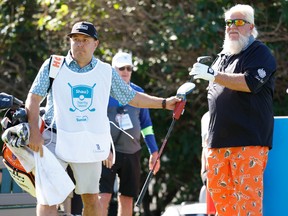 Matt Freeman, head pro at Canyon Meadows Golf and Country Club, caddies for John Daly during the Shaw Charity Classic at Canyon Meadows in Calgary on Friday, Aug. 5, 2022.
