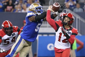 Bombers defensive end Willie Jefferson knocks the ball out of the hands of quarterback Jake Maier.
