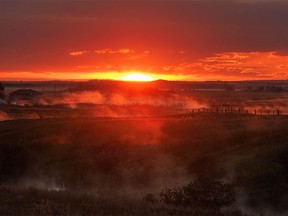 The sun rises over a misty irrigation canal near Keoma, Ab., on Wednesday, September 7, 2022.