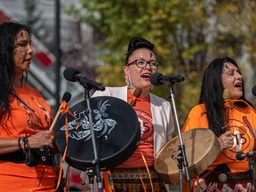 Women of Songs, Debbie Green, left, Pearl White Quills and Wendy Walker perform on Orange Shirt Day at Fort Calgary Sept. 30, 2021.