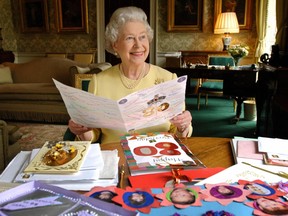 Queen Elizabeth II sits in the Regency Room at Buckingham Palace in London 19 April 2006 as she looks at some of the cards which have been sent to her for her 80th birthday. Buckingham Palace said that so far she has received 20,000 cards and 17,000 emails. The Queen celebrates her actual 80th birthday Friday 21 April.