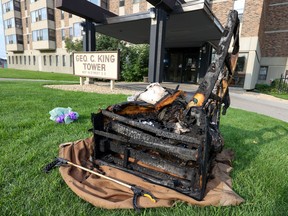 A burned chair and other debris remain outside the George C. King tower in Calgary's East Village after an early morning fire on Thursday, September 1, 2022.