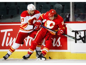 Flames veteran Milan Lucic battles for the puck against Sonny Milano at NHL hockey training camp in Calgary.