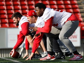 Calgary Stampeders offensive linemen Sean McEwen, Zack Williams and Josh Coker during the walkthrough as the team gets set to play the Toronto Argonauts Saturday at McMahon Stadium in Calgary.