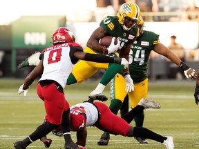 The Edmonton Elks' Kevin Brown tries to get the jump on the Calgary Stampeders' Kobe Williams and Trumaine Washington during first-half CFL action at Commonwealth Stadium in Edmonton on Saturday, Sept. 10.