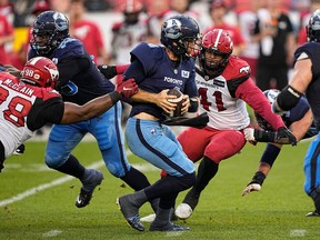 Stampeders defensive linemen Terrell McClain and Mike Rose close in before sacking Toronto Argonauts quarterback McLeod Bethel Thompson during a recent game  at BMO Field.
