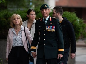 Maj.-Gen. Dany Fortin, right, arrives with his wife Madeleine Collin as he arrives at a Gatineau, Que. courthouse ahead of the second day of his trial on Tuesday, Sept. 20, 2022.