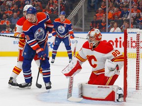 Edmonton Oilers forward Zach Hyman looks for a rebound in front of Calgary Flames goaltender Dan Vladar during a pre-season game at Rogers Place in Edmonton on Friday, Sept. 30, 2022.