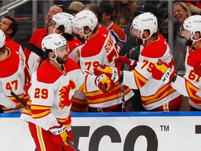 The Calgary Flames celebrate a goal by forward Dillon Dube against the Edmonton Oilers at Rogers Place on Friday, Sept. 30, 2022.