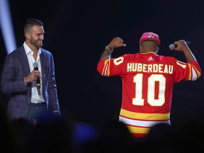 Jonathan Huberdeau, left, opens the show during the 2022 Canadian Country Music Awards show in Calgary on Sept. 11.
