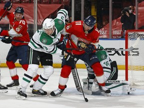 Jonathan Huberdeau battles in front of Dallas Stars goaltender Anton Khudobin during a game on Feb. 22, 2021.