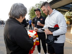 Jonathan Huberdeau signs a jersey during the Calgary Flames Celebrity Charity Golf Classic on Wednesday.